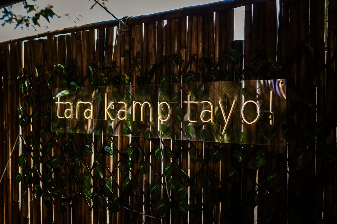 Neon sign: tara kamp tayo! — Kamp Lilim bamboo wall